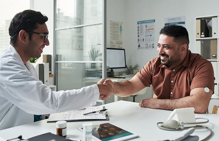 Doctor and patient greeting happily